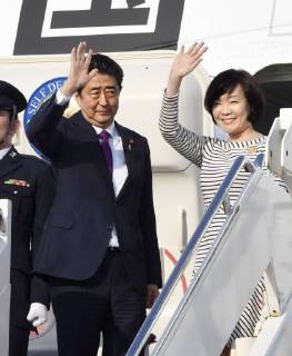 Japan PM Abe Japanese Prime Minister Shinzo Abe (L), alongside his wife Akie, waves before leaving Joint Base Andrews near Washington on June 7, 2018, for a Group of Seven summit in Quebec, Canada.