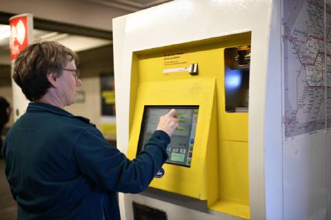 elderly woman buys ticket at ticket vending machine BVG Berliner Verkehrsbetriebe Berlin Germany Berlin