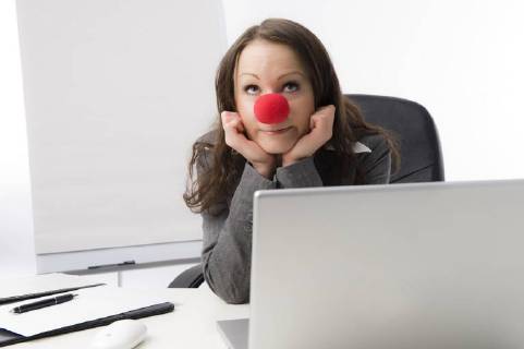 Geschaeftsfrau mit roter Clownnase business woman with red nose BLWS486078 Copyright: xblickwinkel McPHOTO M.xBegsteigerx