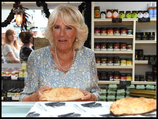 . 16 07 2018. Fowey, United Kingdom. Prince Charles the Duchess of Cornwall visit Cornwall. The Duke and Duchess of Cornwall with a cornish pasty visit the celebration of Fowey festival meeting local businesses, representatives from Fowey gig club and members of the RNLI on Fowey Quay.  xAndrewxParsonsx xi-Imagesx IIM-18220-0066
