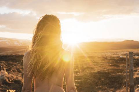 Iceland, rear view of naked young woman at sunset model released Symbolfoto  KKAF01105