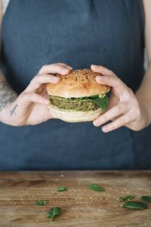 Woman holding homemade vegan burger model released Symbolfoto property released  ALBF00396
