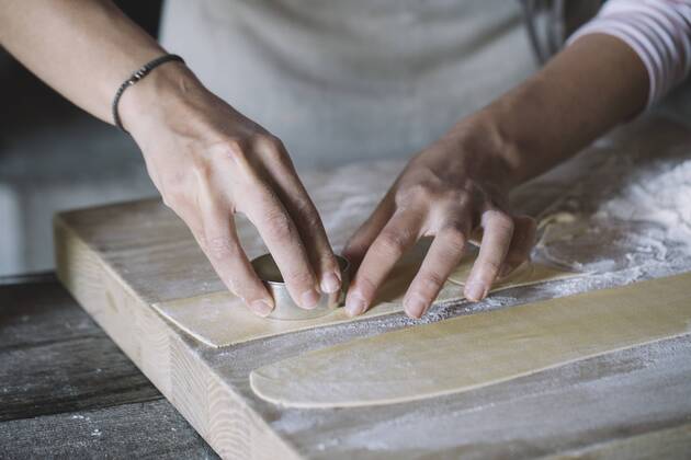 Woman preparing ravioli, pasta dough cutting out on pastry board model released Symbolfoto  ALBF00500