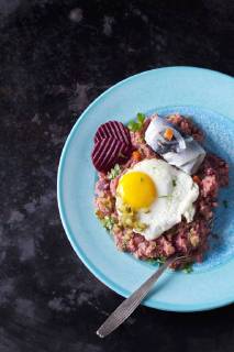 Plate of Labskaus with potatoes, rollmops, pickled gherkin, beetroot and fried egg  CSF29199