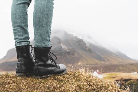 Iceland, legs of woman standing on hill model released Symbolfoto  KKAF00998