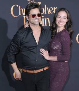 July 30, 2018 - U.S. - 30 July 2018 - Burbank, California - John Stamos, Caitlin McHugh. Premiere of Disney s Christopher Robin held at Walt Disney Studios. Photo Credit: PMA AdMedia U.S. - ZUMAa123 20180730_zaa_a123_225 Copyright: xPmax