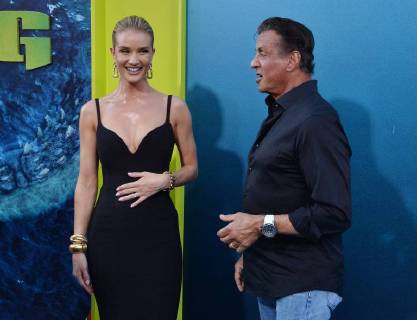 English actress and model Rosie Huntington-Whiteley and actor Sylvester Stallone mingle during the premiere of the sci-fi motion picture thriller The Meg at TCL Chinese Theatre in the Hollywood section of Los Angeles on August 6, 2018. Storyline: After escaping an attack by what he claims was a 70-foot shark, Jonas Taylor must confront his fears to save those trapped in a sunken submersible.  LAP2018080650 JIMxRUYMEN