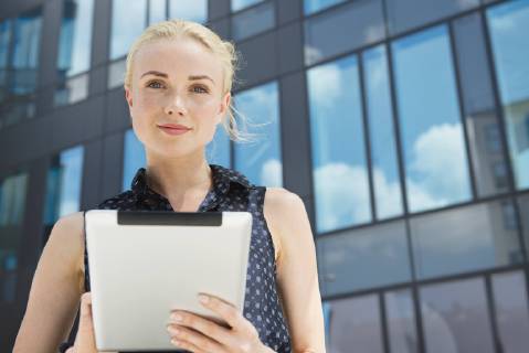 Young businesswoman using digital tablet outdoors  Copyright: EricxAudras B17250329