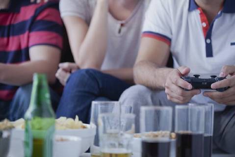Friends playing video games together  Copyright: AlexVentura B34424828