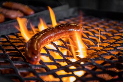 21 08 2018 Berlin Germany GER A sausage is lying on a grate and is being grilled