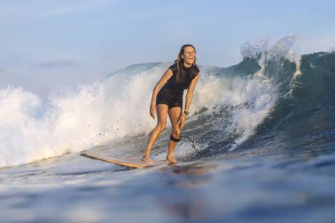 Front view shot of single woman riding wave in sea while surfing, Kuta Lombok Indonesia TRKO020214 model released Symbolfoto Copyright: KonstantinxTrubavin TRKO020214