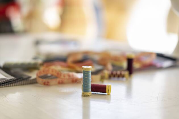 Sewing items on working table in a fashion designer s studio property released  AFVF00759