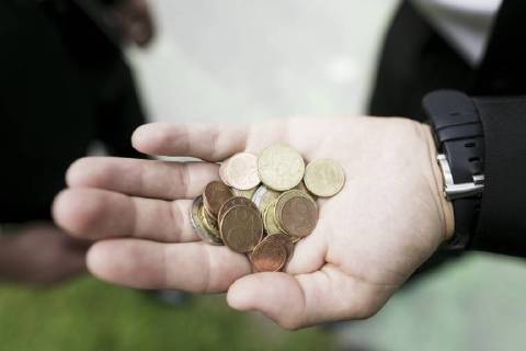 Euro coins in the hand of a businessman model released Symbolfoto  KMKF00382