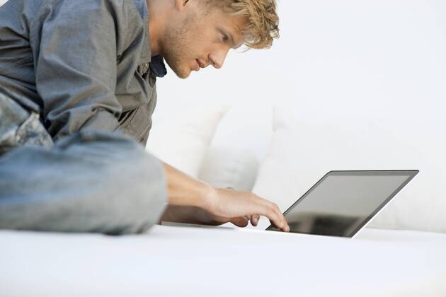Man using laptop computer  Copyright: OdilonxDimier B55985317