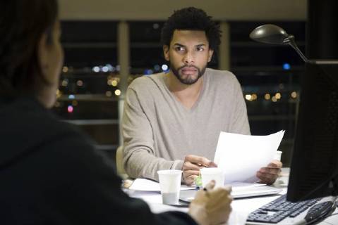 Colleagues working on project together in office at night Copyright: EricxAudras B31800917