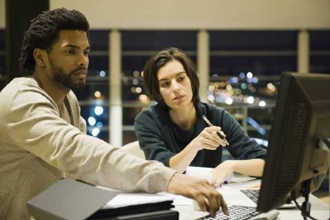 Colleagues working on project together in office at night Copyright: EricxAudras B41104317
