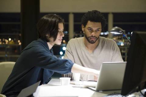 Colleagues working on project together in office at night Copyright: EricxAudras B45607418