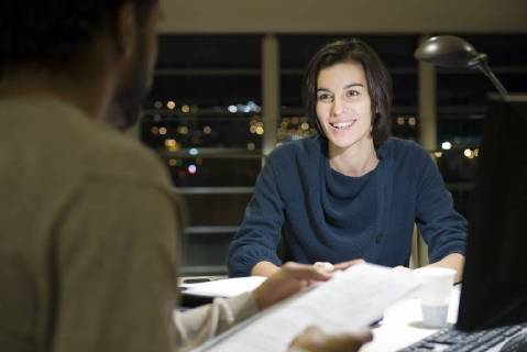 Colleagues working on project together in office at night Copyright: EricxAudras B57307118