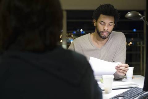 Colleagues working on project together in office at night Copyright: EricxAudras B58508217