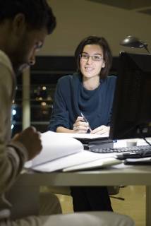Colleagues working on project together in office at night Copyright: EricxAudras B76305317