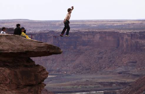 Andy Lewis highlining at the Fruit Bowl in Moab, Utah., Moab Utah United States Copyright: JaredxAlden 4517100013