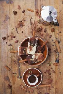 Homemade espresso and white chocolate ice lollies with winter spices, cup of espresso and espresso maker on wooden background  GWF05636