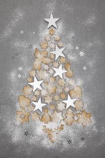Christmas cookies and white stars forming Christmas Ttee on grey background  GWF05618