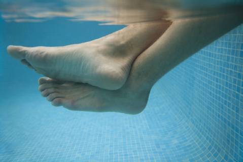 Man s legs in water, underwater view  Copyright: AntoinexArraou B97876719