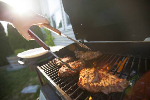 Person preparing meat on barbecue grill, Surrey British Columbia Canada model released Symbolfoto property released Copyright: ChristopherxKimmel KICH014955