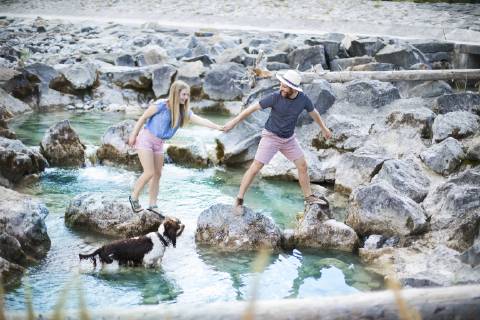 Young couple crossing river model released Symbolfoto property released  MAEF12694