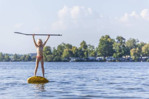 Young girl stand up paddle surfing model released Symbolfoto  TCF05662