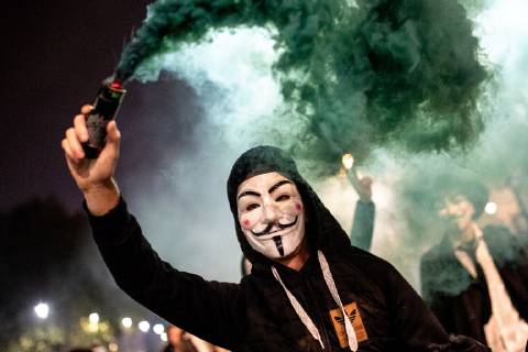 November 5, 2018 - London, London, UK - London, UK. A demonstrator lights a flare as he takes part in the Million Mask March, an anti-capitalist protest organised by Anonymous UK. The march takes place on bonfire night, the anniversary of Guy Fawkes plot to blow up the Houses of Parliament with gunpowder. London UK  - ZUMAl94_ 20181105_zaf_l94_067 Copyright: xTomxNicholsonx