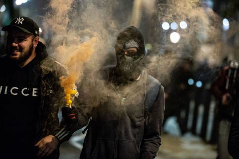 November 5, 2018 - London, London, UK - London, UK. A demonstrator lights a flare as he takes part in the Million Mask March, an anti-capitalist protest organised by Anonymous UK. The march takes place on bonfire night, the anniversary of Guy Fawkes plot to blow up the Houses of Parliament with gunpowder. London UK  - ZUMAl94_ 20181105_zaf_l94_069 Copyright: xTomxNicholsonx