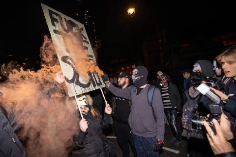 November 5, 2018 - London, London, UK - London, UK. A demonstrator lights a flare as he takes part in the Million Mask March, an anti-capitalist protest organised by Anonymous UK. The march takes place on bonfire night, the anniversary of Guy Fawkes plot to blow up the Houses of Parliament with gunpowder. London UK  - ZUMAl94_ 20181105_zaf_l94_068 Copyright: xTomxNicholsonx