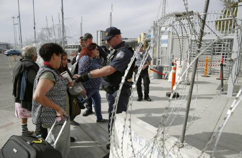 Migrant caravan Migrants from Central America have their backgrounds checked in Tijuana on the Mexican side of the border with the United States on Nov. 19, 2018. 