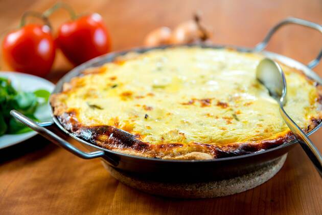  baked quiche with field salad on wooden table  Copyright: xarnoaltixx Panthermedia15874703