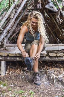 Young woman sitting on bench lacing her hiking boots model released Symbolfoto property released  TCF05834