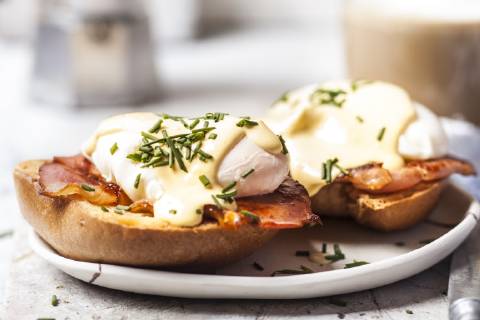 Traditional egg benedict with slices of bacon on toast, poached egg and hollandaise  SBDF03826