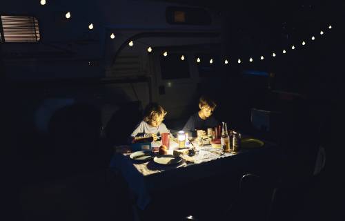 Brazil, Bonito, two boys drawing at camper in the dark model released Symbolfoto property released  SSCF00010