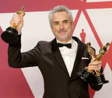 Alfonso Cuaron, winner of Best Foreign Language Film, Best Director and Best Cinematography for Roma, appears backstage with his Oscars during the 91st annual Academy Awards at Loews Hollywood Hotel in the Hollywood section of Los Angeles on February 24, 2019.  LAP20190224756 JOHNxANGELILLO
