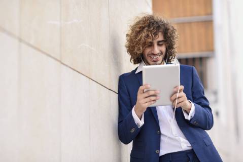 Portrait of young businessman using digital tablet outdoors model released Symbolfoto  JSMF00671