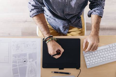 Close-up of man working at home using graphics tablet model released Symbolfoto property released  JRFF02172