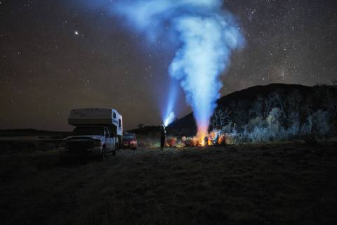 Chile, Tierra del Fuego, Lago Blanco, campfire and people at camper under starry sky at night model released Symbolfoto property released  SSCF00272