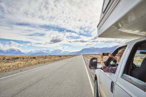 Argentina, Patagonia, El Chalten, woman taking cell phone picture in camper on road towards Fitz Roy model released Symbolfoto property released  SSCF00300
