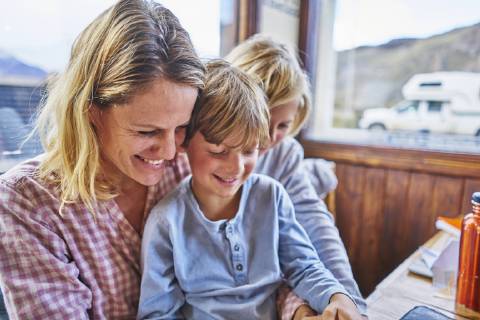 Happy mother with two sons sitting at table in a cafe model released Symbolfoto  SSCF00317