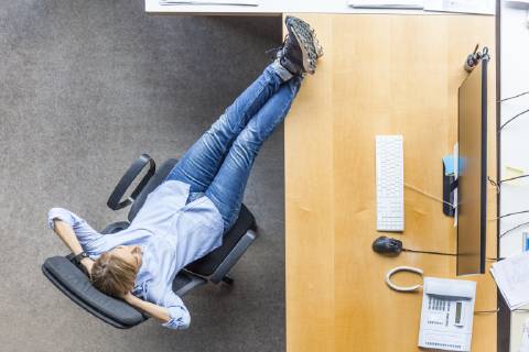 Top view of woman relaxing in chair at desk in office model released Symbolfoto property released  TCF06036