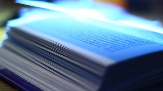 Oped book on the desk very close up Oped book on the desk close up  1069500190