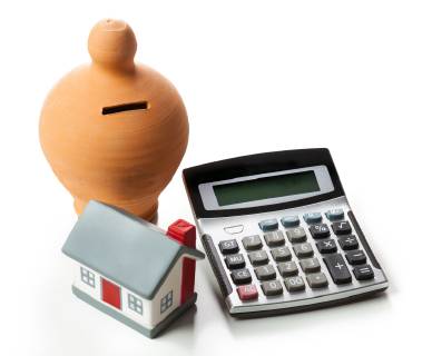 The concept of financial savings to buy a house Money box and calculator isolated on white background  1085306935