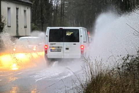 Dangerous road conditions during heavy rain The water from a road flooded after heavy rain is torn into the air by the cars and causes many drivers to be terrified Essen Nordrhein Westfalen Germany Deutschland Überruhr