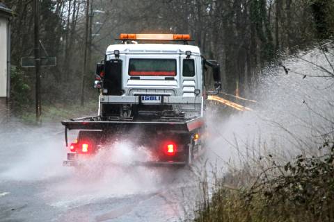Dangerous road conditions during heavy rain The water from a road flooded after heavy rain is torn into the air by the cars and causes many drivers to be terrified Essen Nordrhein Westfalen Germany Deutschland Überruhr